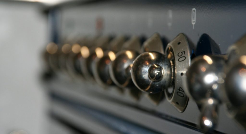 Close-Up View of Temperature Knobs on High-Powered Stove